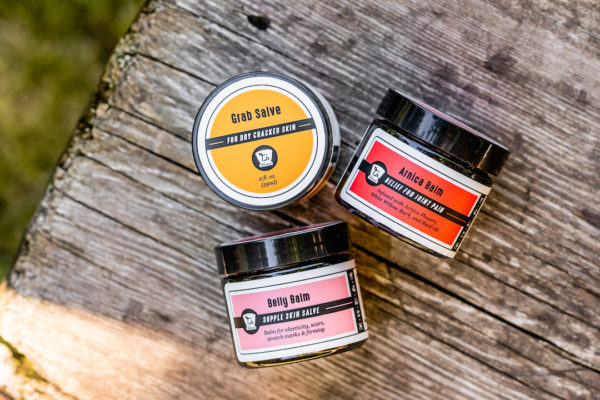 trio of salve jars on log